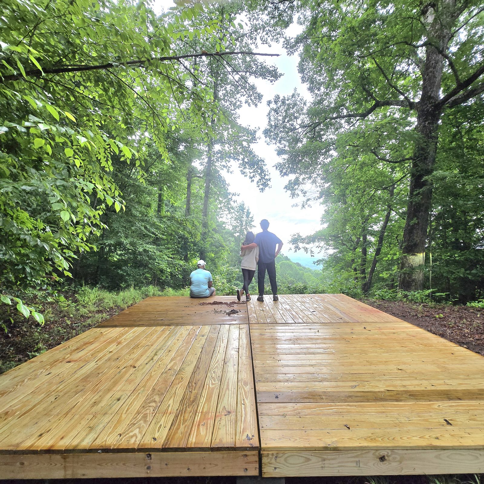 Campers on a wooden tent deck at Cardinal Mountain Campground near Franklin NC